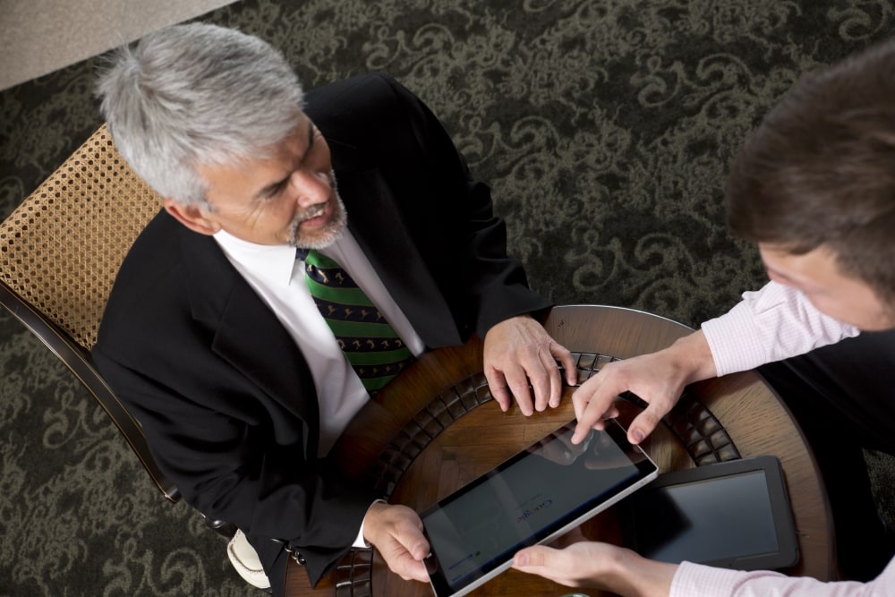 Two Men Working on Tablet